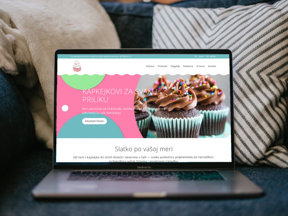New Sisters Cupcakes website on a laptop on a sofa